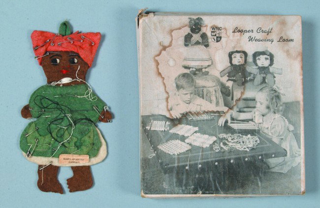 Black Memorabilia Pin Cushion, 7 1/2"h.; felt asse: Black Memorabilia Pin Cushion, 7 1/2"h.; felt assemblage with tag: "Hard Heahted Hannah" with many needles and pins. Along with a Looper Craft Weaving Loom in box, by Wool Novelty Co., NY, NY. Conditi