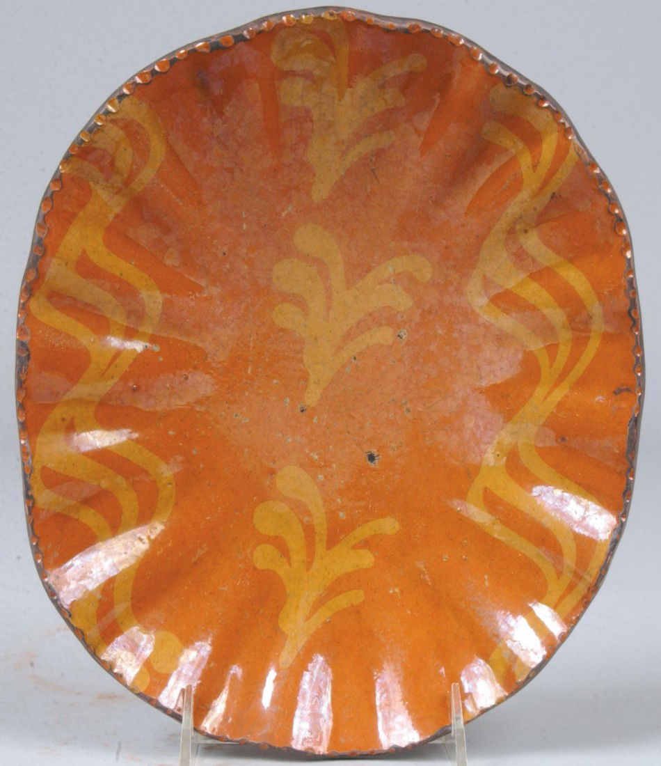 Shooner Marked Slip Decorated Redware Platter, ripp: Shooner Marked Slip Decorated Redware Platter, rippled edge with yellow slip designs, coggle rim. Marked: "Greg Shooner, 2002" 10 1/4"l. Condition: Good