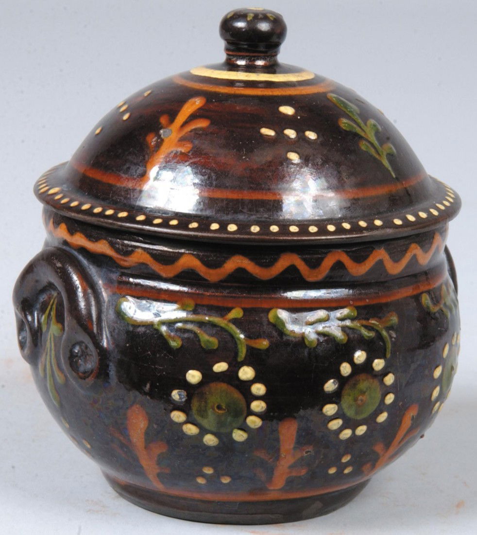 Dome Covered Round Redware Jar, applied handles, ma: Dome Covered Round Redware Jar, applied handles, manganese ground with red, green and white slip flowers and other dot and line designs. Marked: "Greg Shooner, 2003. 5 1/2"h. Condition: Good