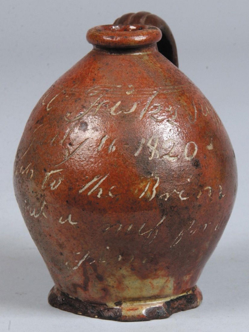 Small Inscribed Redware Jug, marked: "Joel Frisk's: Small Inscribed Redware Jug, marked: "Joel Frisk's Jug, July 16, 1820, Fill this up to the brim, it holds just a nuf for Uncle Jim" 4"h. Condition: loop handle is a replacement, series of chips to bas
