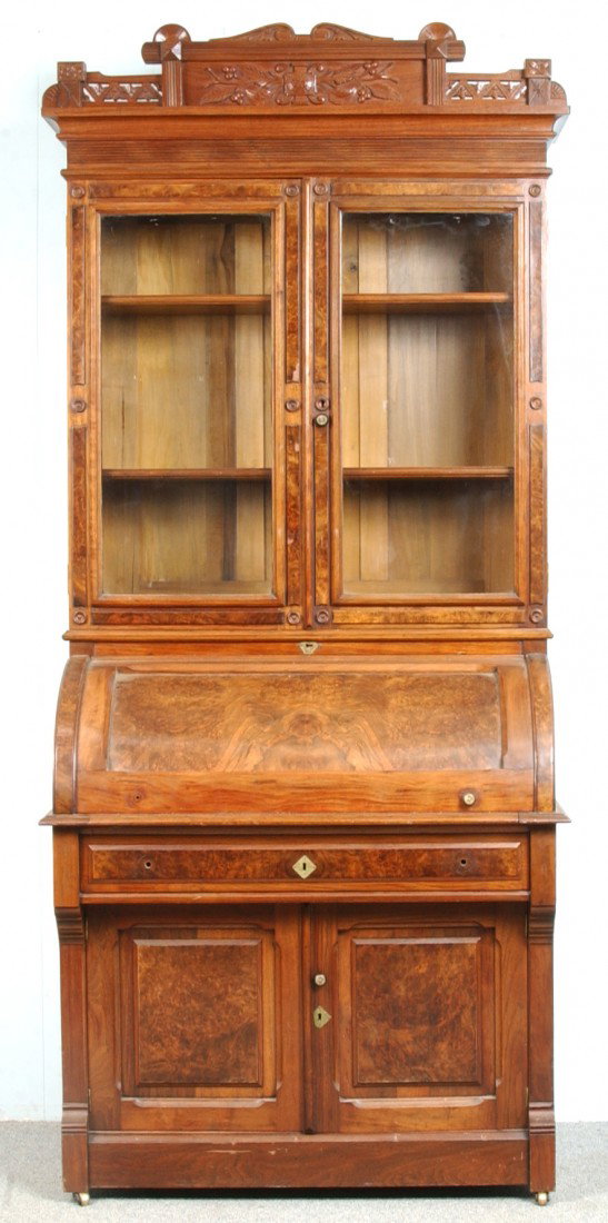 Victorian Walnut and Burl Walnut Cylinder Front Se: Victorian Walnut and Burl Walnut Cylinder Front Secretary Desk. Carved and molded cornice, two glazed bookcase doors, roll front desk compartment with interior drawers and compartments, full width ski
