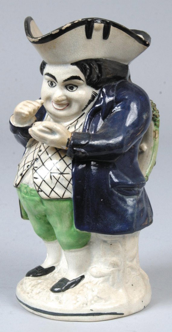 Pratt Ware Toby Jug, circa. 1800-1820. Full figure: Pratt Ware Toby Jug, circa. 1800-1820. Full figure standing Toby holding a snuff box. 8 1/4" high. Condition: some glaze flakes on top rim.