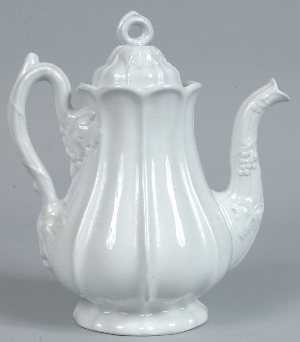 White Ironstone China "Paneled Grape" Teapot with : White Ironstone China "Paneled Grape" Teapot with embossed grape and leaf design on ribbed bulbous body. 10 1/4" high. Condition: good.