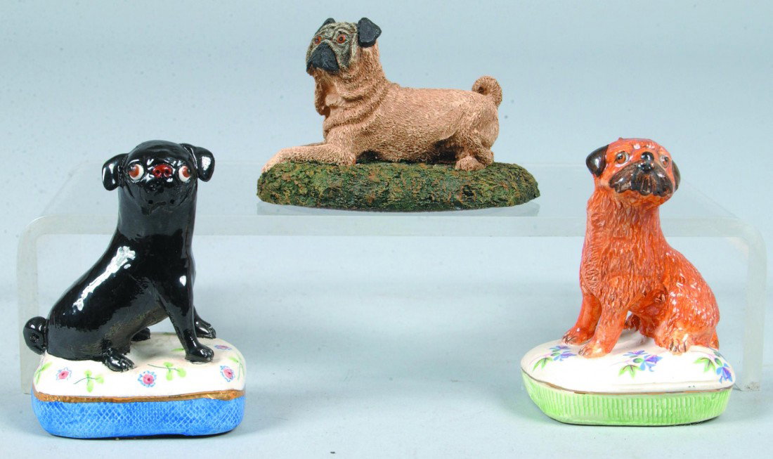 3 Pug Castings, 3"l.; two painted ceramic Pugs on : 3 Pug Castings, 3"l.; two painted ceramic Pugs on pillows, one brown, one black, marked: "Basil Matthews, made in England" and a painted composition Pug lying on grass, marked: "Marsha Richardson, Boo