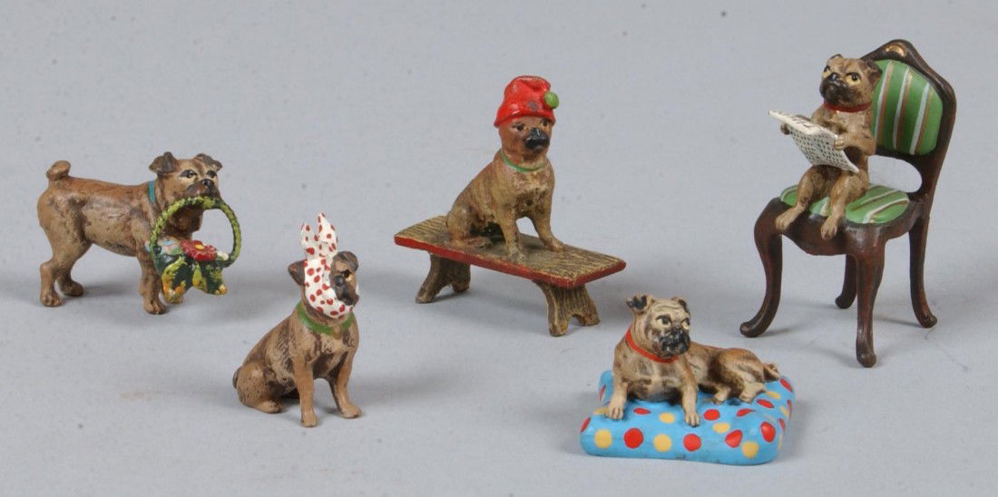 Five Piece Group of Cold Painted Vienna Bronze Cas: Five Piece Group of Cold Painted Vienna Bronze Castings of Pugs, 1" to 1 1/2"l.; Reader on chair, Red hat on bench, lying on blue pillow, standing with flower basket in mouth, and sitting with toothac