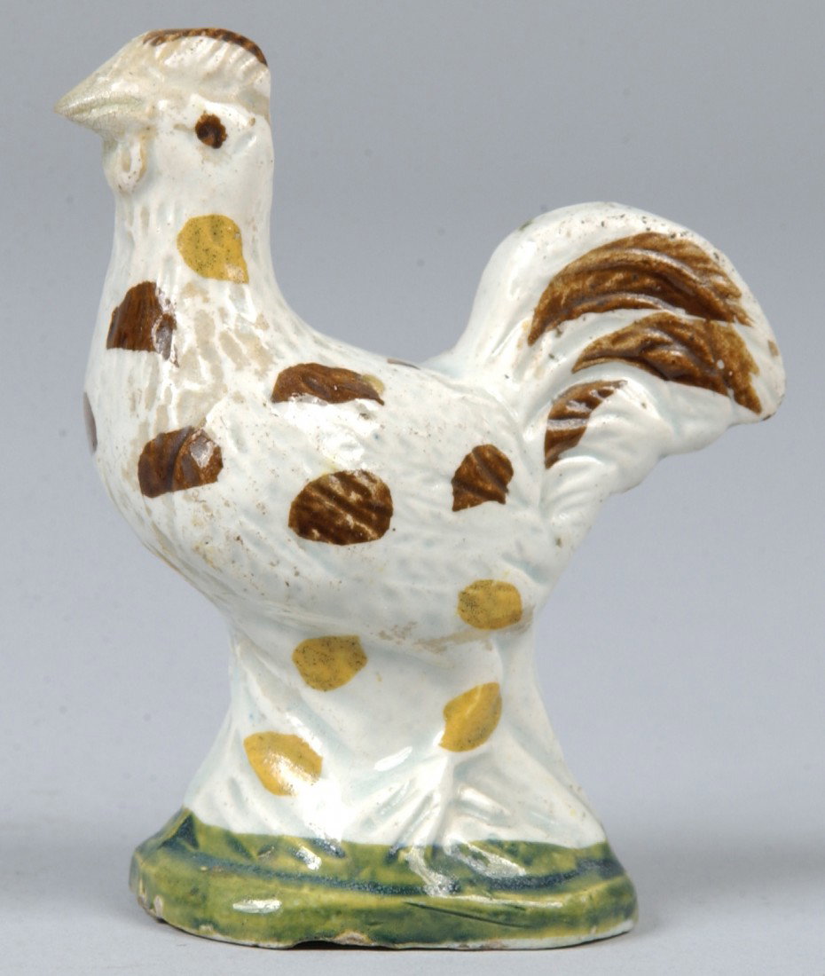 Ralph Wood Chicken Figure, brown and yellow spots : Ralph Wood Chicken Figure, brown and yellow spots on white with green base. Unmarked. 3 1/4"h. Condition: work on beak, two chips under base, one chip on tail.