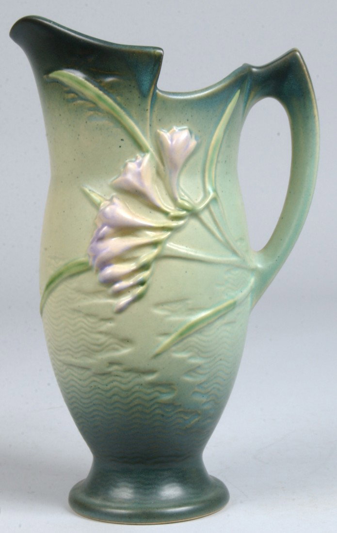 Roseville Freesia Floral Pitcher, dark to light to: Roseville Freesia Floral Pitcher, dark to light to dark green body with purple and white freesia flowers and leaves. Marked: "Roseville USA, 20-10". 10 1/2"h. Condition: Good