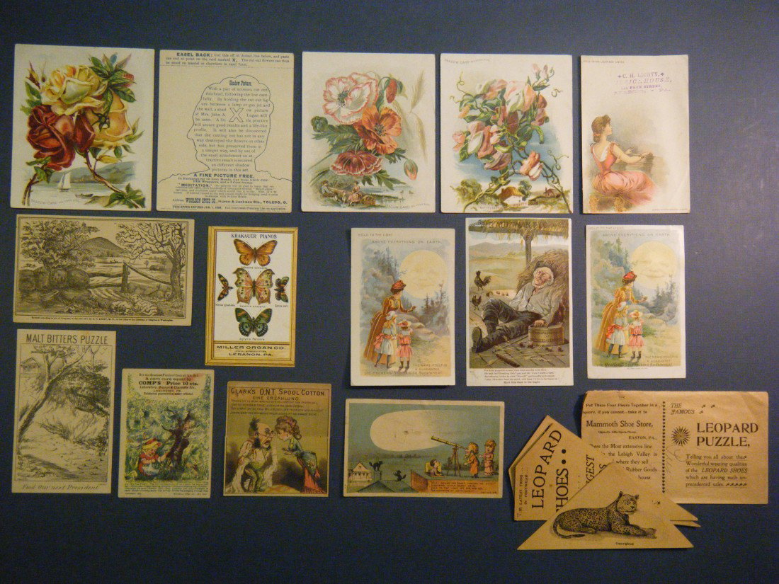 (15 Novelty Trade Cards) Included in this lot are 4: (15 Novelty Trade Cards) Included in this lot are 4 Woolson Spice Co Flower cards/shadow pictures on versos, 4 hidden pictures/puzzles, a punch-out butterflies card, 5 "hold-to-light" cards (incl a du