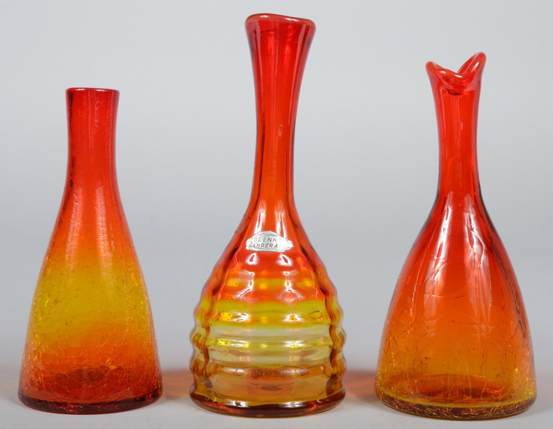 Three Tangerine Blenko Bud Vases, two beaker shape: Three Tangerine Blenko Bud Vases, two beaker shaped crackle glass, unmarked, 7 3/4"h. & 8 1/2"h.; and a beaker shape with rippled sides, tapered and flared neck to mouth, unmarked except for "hand" st