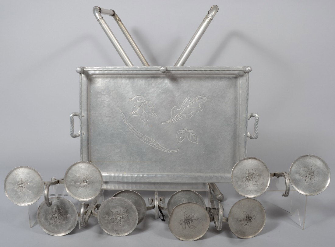 Everlast Aluminum Butler Table with incised leaf d: Everlast Aluminum Butler Table with incised leaf design on tray, 34 1/2"h x 28 1/4"w x 17 3/4"d., plus five lawn double lawn coasters with spike bases by Wendell August Forge. 30 1/2" high. Condition: