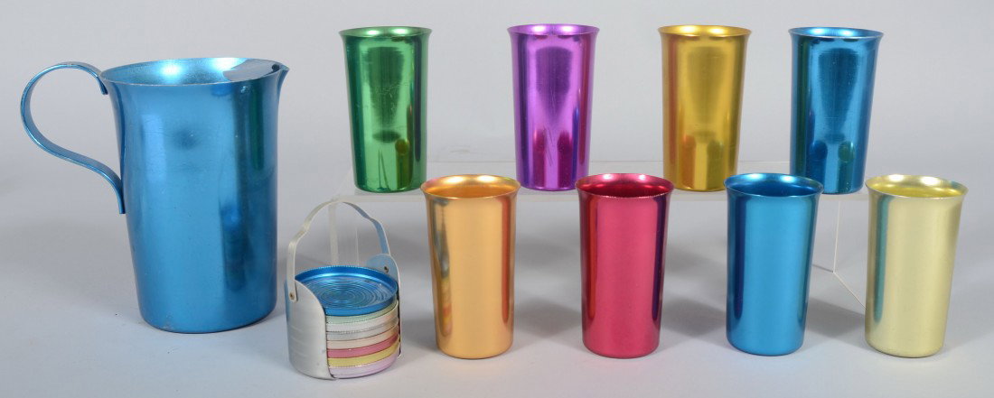 Anodized Aluminum Drink Set in various colors mark: Anodized Aluminum Drink Set in various colors marked Flamingo by Nasco. 7 3/4" pitcher, eight tumblers and a coaster set. Condition: good with normal wear.