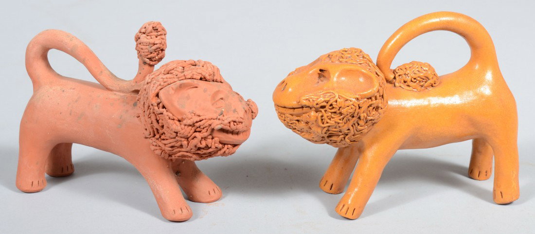 Two Modeled Red Clay Standing Lions. Both naively : Two Modeled Red Clay Standing Lions. Both naively rendered; one 'green', unfinished, and one painted amber. Neither marked, but suspected to be from Springfield Pottery. 6 1/4"l. and 6 1/2"l. Conditio