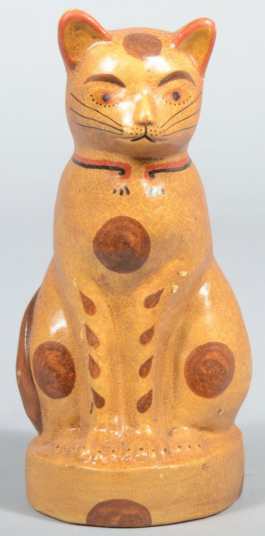 Hollow Cast Redware Seated Cat. Marked: 'Example': Hollow Cast Redware Seated Cat. Marked: 'Example' on back and painted tan with brown 'spots' and folky detail. Springfield mark on base. 7 3/4"h. Condition: Good, with some rubs to finish.
