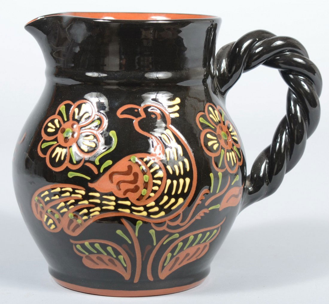 Breininger Pottery Slip Decorated Redware Pitcher.: Breininger Pottery Slip Decorated Redware Pitcher. Overall Black with yellow and green slip highlights on scraffito outlines of a bird with flowers and triple tulip designs on body; applied twisted lo