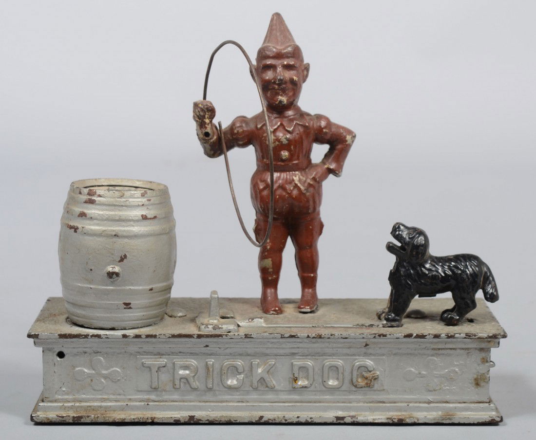 Cast Iron "Trick Dog" Mechanical Bank, clown holds: Cast Iron "Trick Dog" Mechanical Bank, clown holds hoop for dog to drop coin in barrel. No Mfg. mark, only: "Pat. July 31, 1888" on base. 7 1/2"h. X 8 5/8"l. Condition: Out of original paint, coin tra