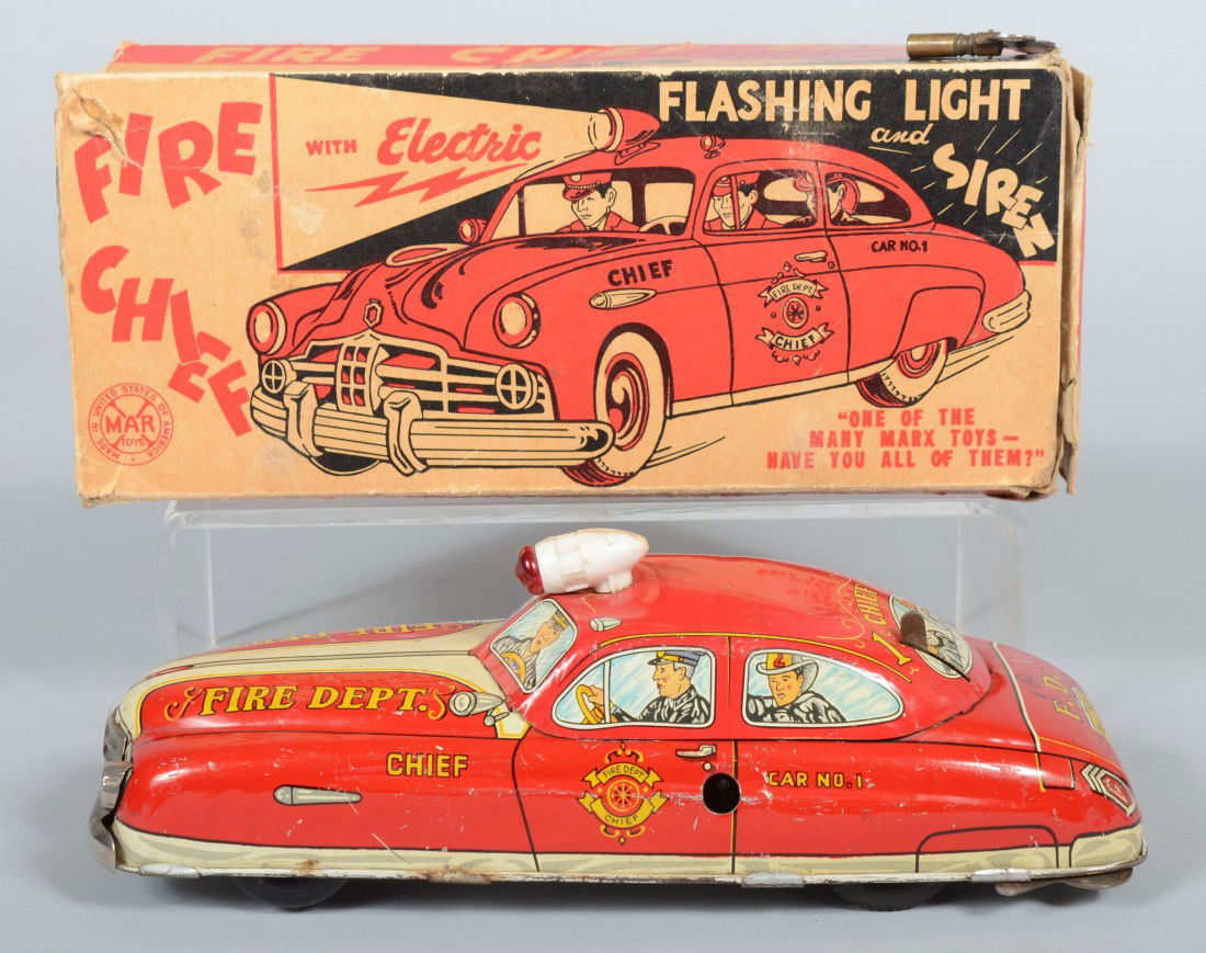 Wind-up Fire Chief's Car with Original Box. Lithog: Wind-up Fire Chief's Car with Original Box. Lithographed tinned sheet iron sedan with three black wood wheels and a rubber drive wheel. Key wind motor with battery for lights and siren. Marked: "Louis