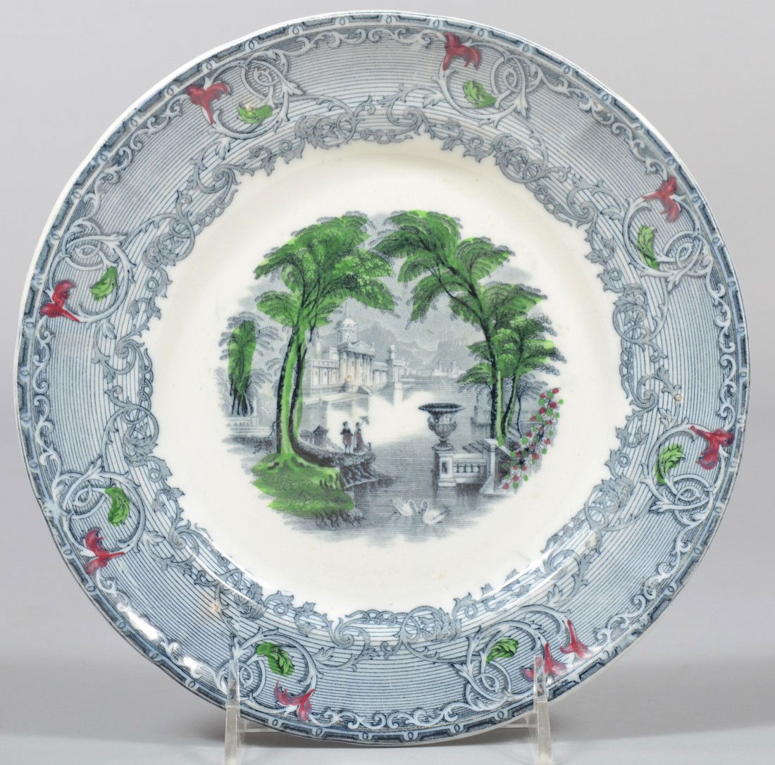 Black Transfer Ironstone Plate, with green and red: Black Transfer Ironstone Plate, with green and red accents, classic water scene. Marked: "Venus, Pearl Stone Ware, P W & Co." 8 3/4" dia. Condition: Good