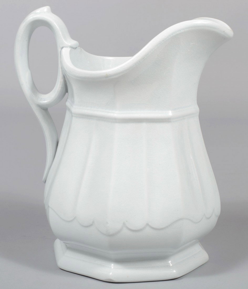 White Ironstone Pitcher, draped octagonal paneled : White Ironstone Pitcher, draped octagonal paneled body, applied handle. Marked: "Wedgwood Ironstone China" 10 1/4"h. Condition: Good