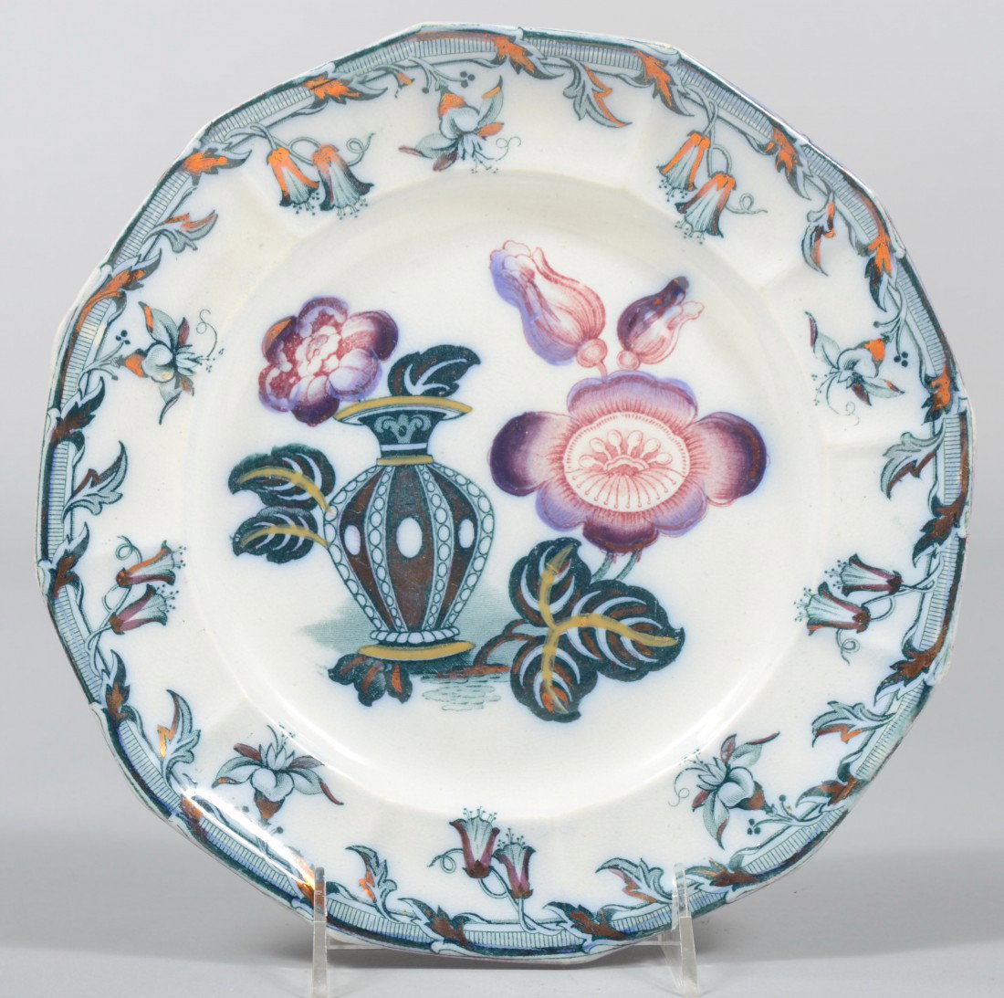Blue Transfer Ironstone Plate, unusual design of u: Blue Transfer Ironstone Plate, unusual design of urn with lotus blossoms center and copper highlighted floral border, 12 sided rim. Impressed on back: "Beard". 9 1/2"dia. Condition: Good