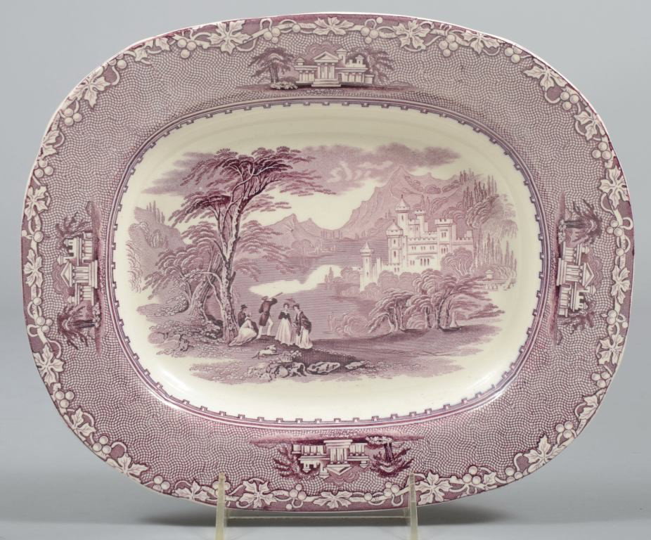 Mauve Transfer Staffordshire Platter, castle scene: Mauve Transfer Staffordshire Platter, castle scene in mountains with touring group in foreground, trailing vine on border. Marked: "Jenny Lind, C. M. & S."(Charles Meigh and Son) 10 1/2 l.X 8 1/2"w. C