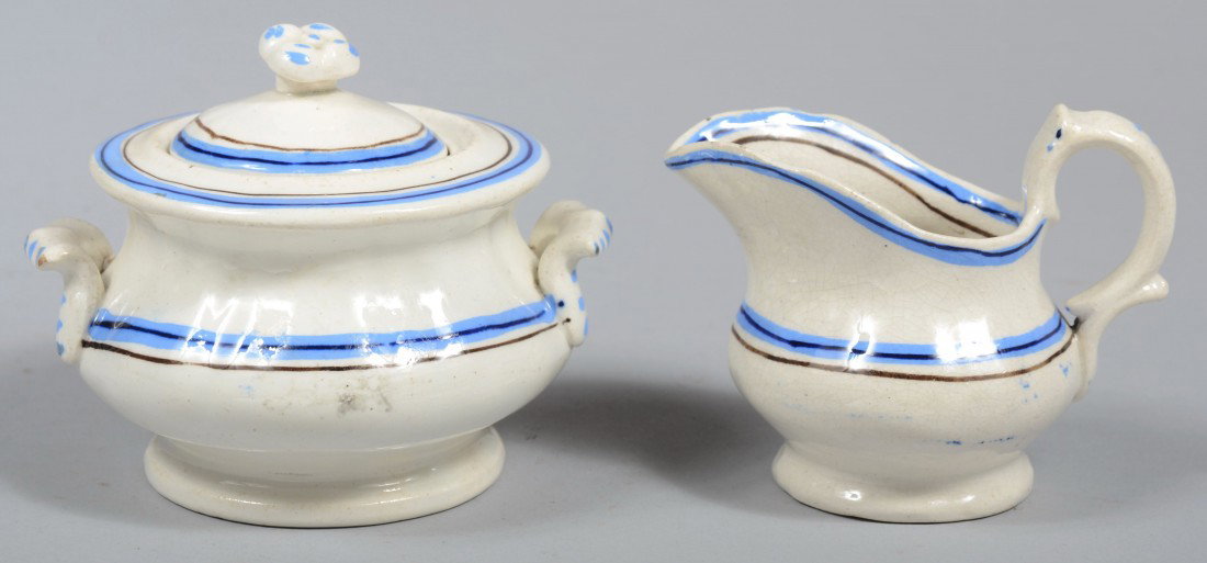 Striped White Ironstone Child's Covered Sugar and : Striped White Ironstone Child's Covered Sugar and Creamer, blue with black stripe decoration, applied handles and finial with raised foot. Unmarked. 3 1/2"h. & 2 3/4"h. Condition: Good