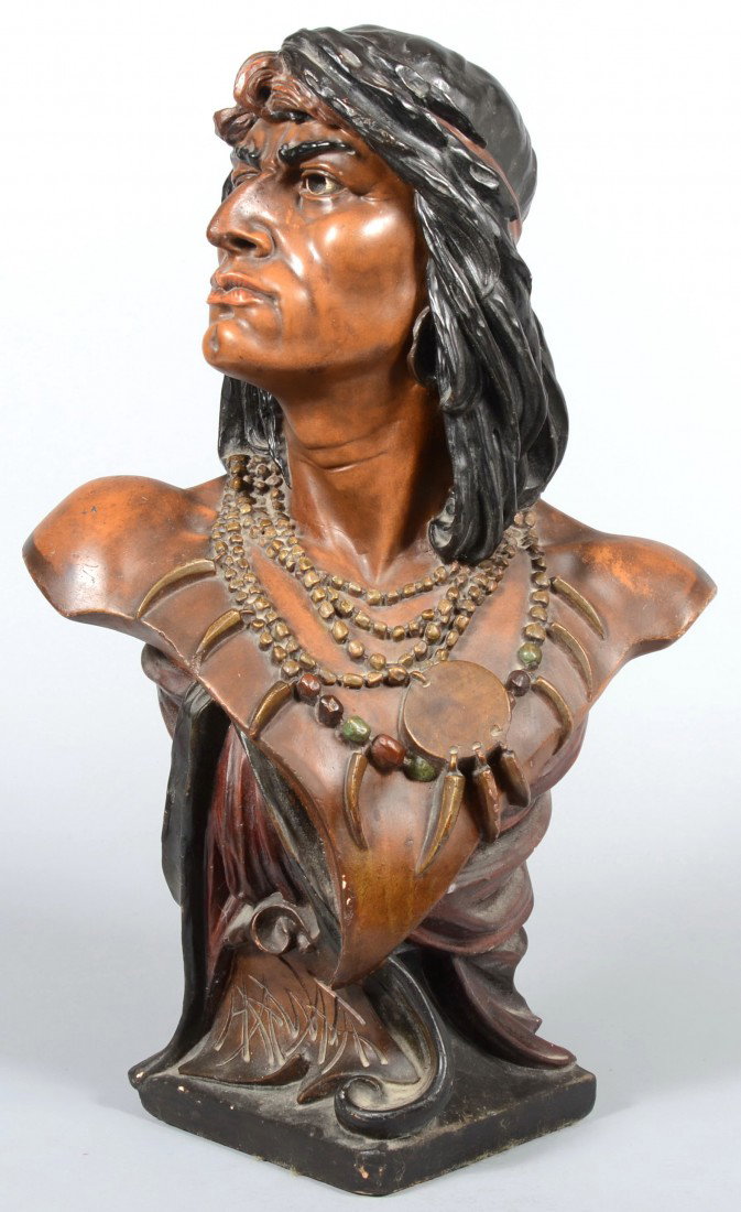 Large Polychrome Plaster Bust of Indian Brave mark: Large Polychrome Plaster Bust of Indian Brave marked: "Hiawatha" on base. Noble savage has black hair with head scarf, earrings, beaded necklaces with bear claws and decorative fabric gathers beneath