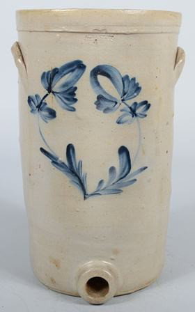 Tall Cobalt Decorated Stoneware Cooler with Spigot: Tall Cobalt Decorated Stoneware Cooler with Spigot Socket. Impressed "Albany, NY, 4." with two blue tulips on face, crescent handles applied to sides, socket at base. 16 1/2"h. X 9 3/4"dia. Condition: