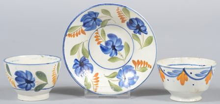 Three Pieces Leeds Soft Paste, Child's Tea Cups wi: Three Pieces Leeds Soft Paste, Child's Tea Cups with Saucer. Matching hand painted floral Bute type handless cup and saucer. Unmarked. 1 3/4"h. & 4"dia.; along with a London type handless cup with swa