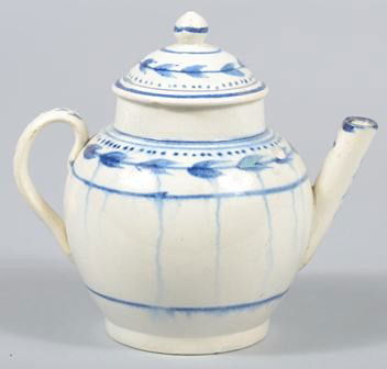 Leeds Soft Paste Child's Teapot, blue foliate deco: Leeds Soft Paste Child's Teapot, blue foliate decoration. Unmarked. 4 1/4"h. Condition: Spout has been reattached and a void filled at base of spout, crack spider behind handle, crack in bottom, lid h