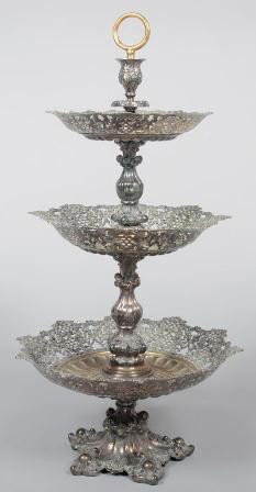 Silver Plated Three Tier Epergne, reticulated sid: Silver Plated Three Tier Epergne, reticulated sides to each tier level, balister shaped shaft sections, five foot base. Marked: "Warszawa Plaque, Fraget"; 28"h. X 14"dia. Condition: wear to plating, t
