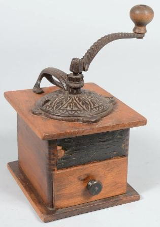 Cast Iron Mounted Wood Box Coffee Grinder. Attach: Cast Iron Mounted Wood Box Coffee Grinder. Attached paper label states: "Challenge Fast Grinder, No. 1087 Coffee Mill." Includes original drawer. 10 1/2"h. X 5 3/4"w. X 7 1/4"d. Condition: Good.