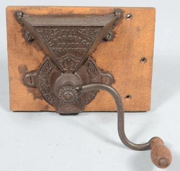 The C. Parker Co., No. 350 Wall Mounted Coffee Mi: The C. Parker Co., No. 350 Wall Mounted Coffee Mill. Mounted on an attachment board, device has hinged lid, 'S' crank with wood knob, marked on front. 6"h. X 5 7/8"w. / board: 6 1/8"h. X 8 3/8"w. Cond