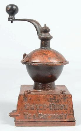 Cast Iron Coffee Mill. Marked: "Grand Union Tea C: Cast Iron Coffee Mill. Marked: "Grand Union Tea Company" on receiver door; remnants of white and red over paint; hopper with swivel cover and topped by wood knobbed crank. Screwed to a contoured wood 