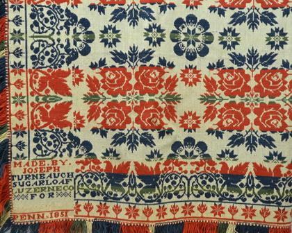 Wool on Cotton Coverlet; white cotton warp with b: Wool on Cotton Coverlet; white cotton warp with blue; green, white and red wool weft; fringe on three sides. Corner legend reads: "Made by Joseph Turnbaugh, Sugarloaf, Luzerne County, Penn 1851". Patt