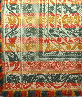 Coverlet. Green, Red and Gold Wool on White Cotto: Coverlet. Green, Red and Gold Wool on White Cotton with Six Point Star in Center and Grapevine Border. Fringe on three sides. No identification. 95"l. X 84"w. with fringe. Condition: Good.