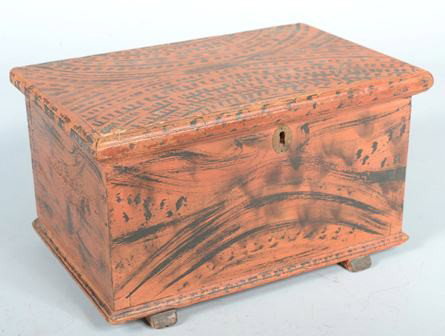 Black on Red Faux Grained Chest with shoe feet, m: Black on Red Faux Grained Chest with shoe feet, molded edge lid and base boards. Dovetail construction with butt hinges, brass lock, hasp, key escutcheon and an interior glove box. 7 3/4"h. X 13 5/8"w