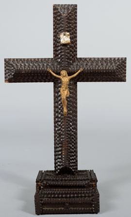 Tramp Art Crucifix on Stepped Box. Dark stained a: Tramp Art Crucifix on Stepped Box. Dark stained and shellacked cross mounted into a stepped chip carved box. Six layer cross bears a gold painted metal Christ figure and a porcelain legend scroll. 17 
