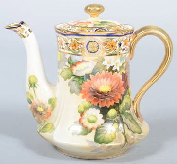 Hand Painted Nippon Polychrome Floral and foliate: Hand Painted Nippon Polychrome Floral and foliate decorated Teapot with gilt highlights, 7 3/4" high. Condition: good.