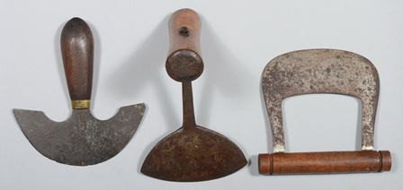 Three Hand Forged Choppers, crescent with wood "T: Three Hand Forged Choppers, crescent with wood "T" crossed handle, 7"h.; double tang with wood handle, marked: "Universal, L. F. & C.", 5 1/4"w.; and a crescent leather knife, marked: "W. Rosh, West P