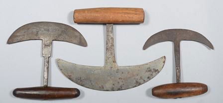 Three Hand Forged Food Choppers, three crescent s: Three Hand Forged Food Choppers, three crescent shaped knives with wood "T" handles in graduated sizes. 9 3/8"w.; 7"w.; and 6"w. Condition: Good.