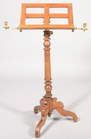 Walnut Victorian Music Stand with two brass candl: Walnut Victorian Music Stand with two brass candle sconces. Flat profile cut legs support a turned shaft with adjustable sheet music platform. Hinged sconces are attached at lower corners. 45 1/2"h. X
