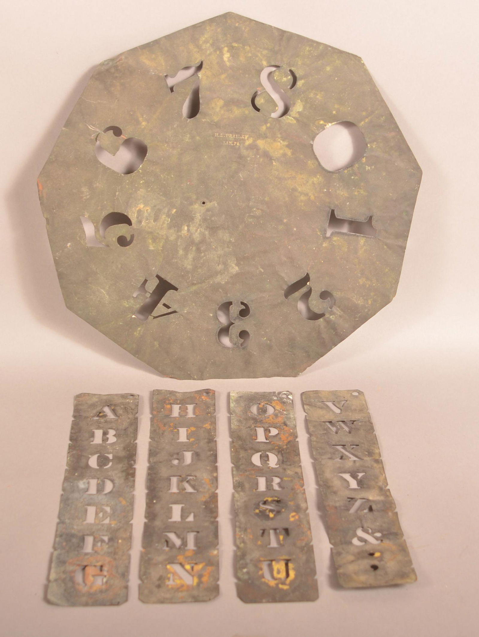 Brass Number Stencil "H L Frailey, Lan. PA".: 19th Century Brass Number Stencil Signed "H L Frailey, Lan. PA". 15-1/2" diam. Along with four vertical alphabet stencils. Condition: Good with dents and wear.