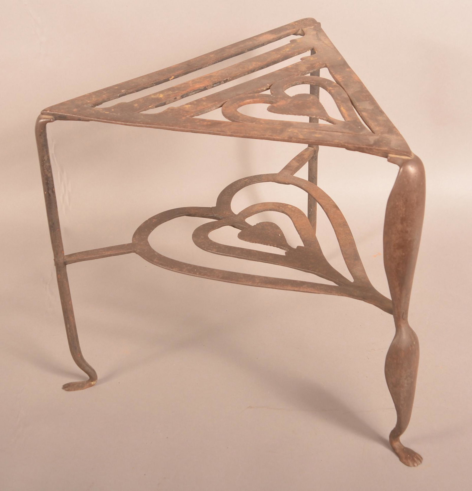 19th Century Cast and Wrought Iron Hearth Trivet.: 19th Century Cast and Wrought Iron Hearth Trivet. Heart and scroll design. 15"h. Condition: Good with scattered rust and one small crack.