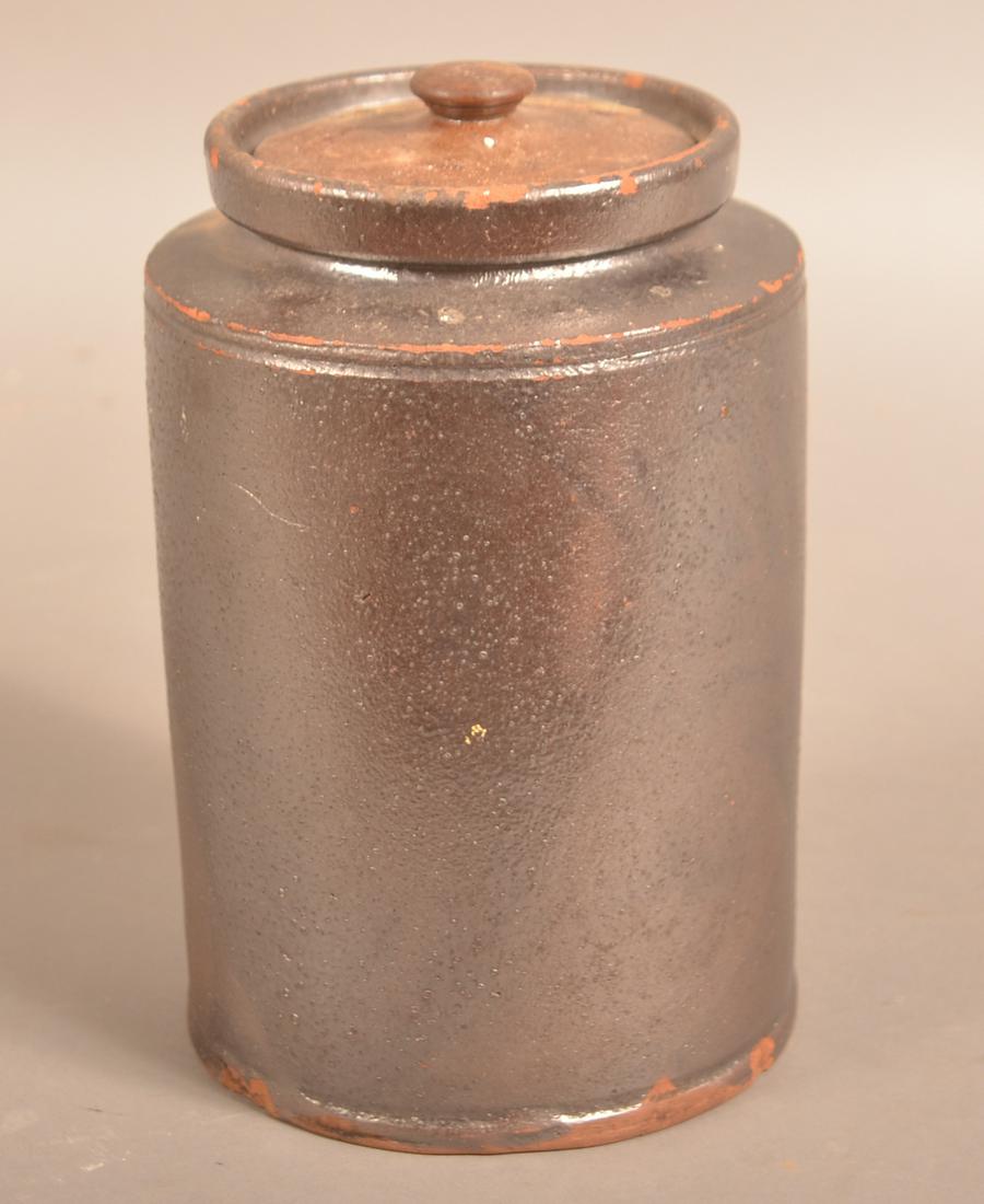19th Century PA Manganese Glazed Redware Jar.: 19th Century Pennsylvania Manganese Glazed Redware Covered Jar. 8-1/4"h. Condition: Good with chips, original lid with repair.