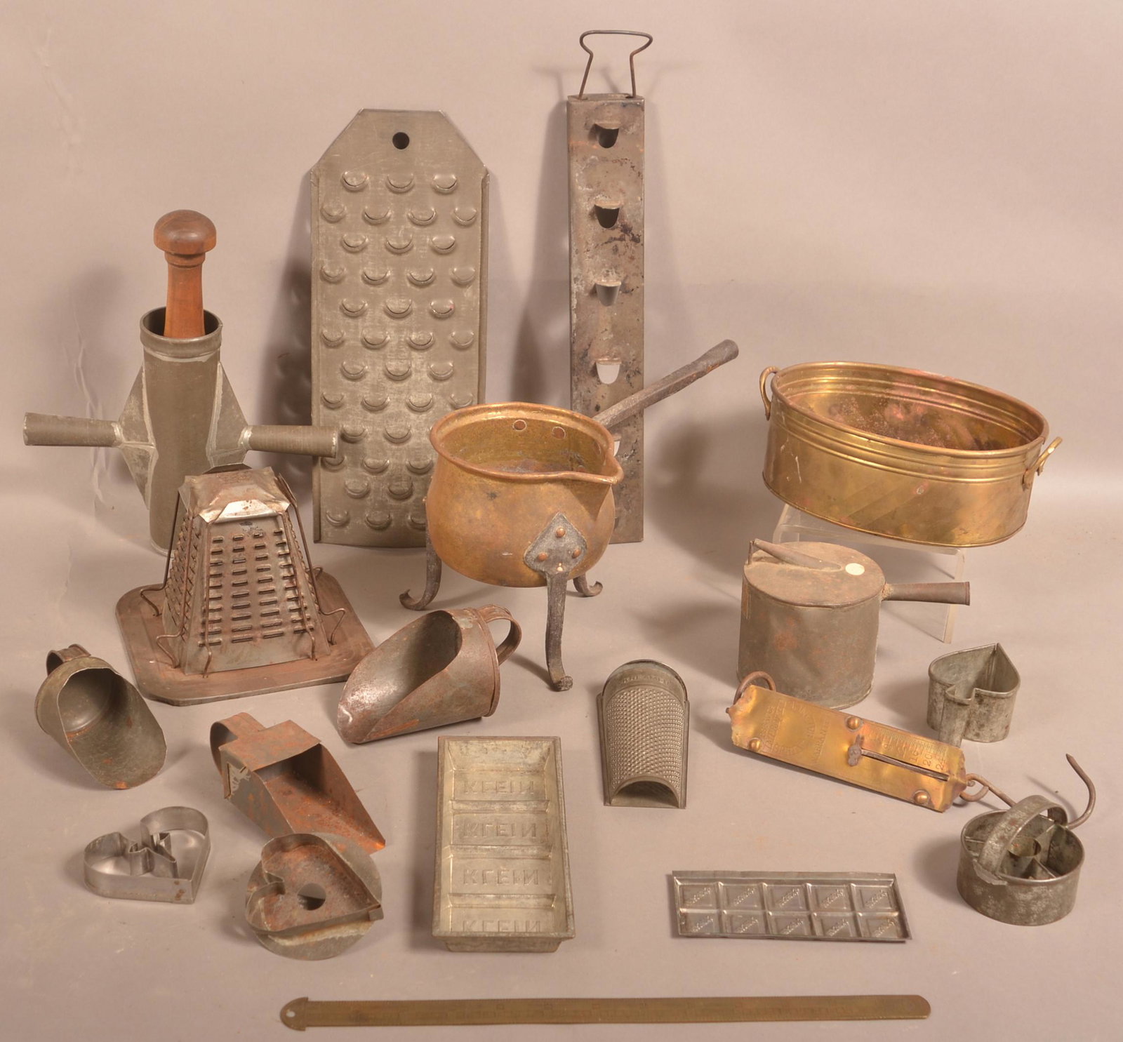 Lot of Antique Tin and Brass Kitchen Items.: Lot of Antique Tin and Brass Kitchen Items. Including Sausage Stuffer, Graters, Toaster, Scale, Apple Roaster, Cookie Cutters, etc. Apple roaster measures 13-1/2"l. Condition: Good with use wear and s