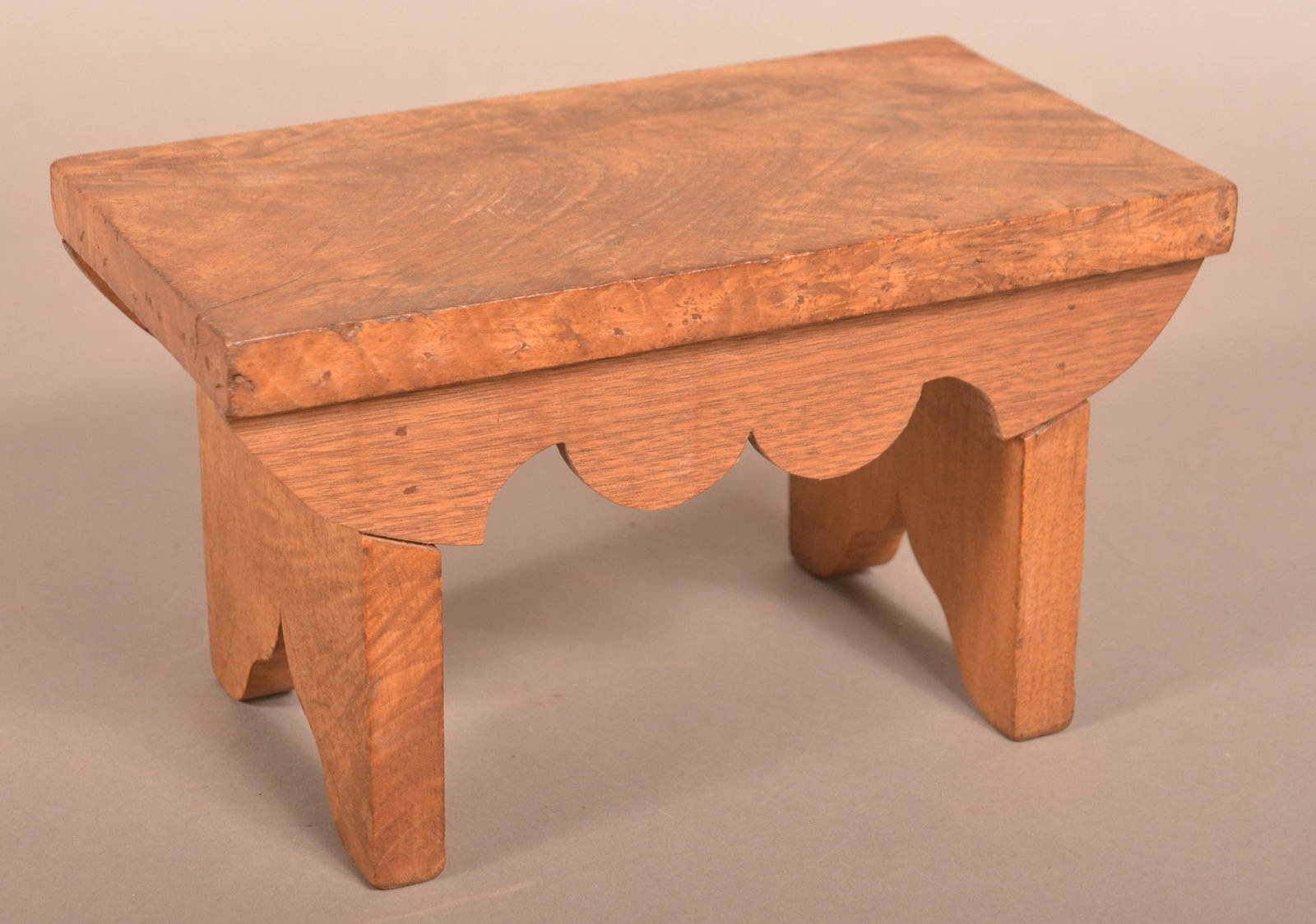 Small Burl Walnut Footstool with Scalloped Skirts.: Small Burl Walnut Footstool with Scalloped Skirts. 6-1/2"h. x 11-1/2"w. x 6-1/2"d. Condition: Good with small age cracks and a corner repair.
