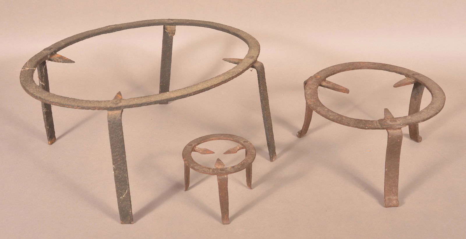 Three 18th/19th Century Wrought Iron Trivets.: Three 18th/19th Century Wrought Iron Trivets. Largest 8"h. x 17-1/2"w. Condition: Good with scattered rust, pitting and use wear.