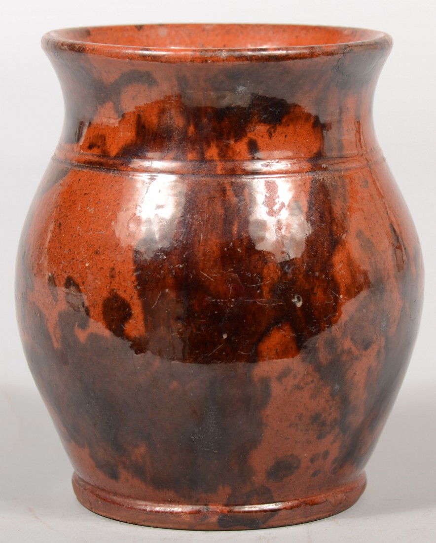 Open Redware Jar or Vase. Bulbous body with flared: Open Redware Jar or Vase. Bulbous body with flared rim, two incised lines and bead foot. Mottled manganese decoration. Unmarked. 5 7/8"h. Condition: Two filled rim chips.