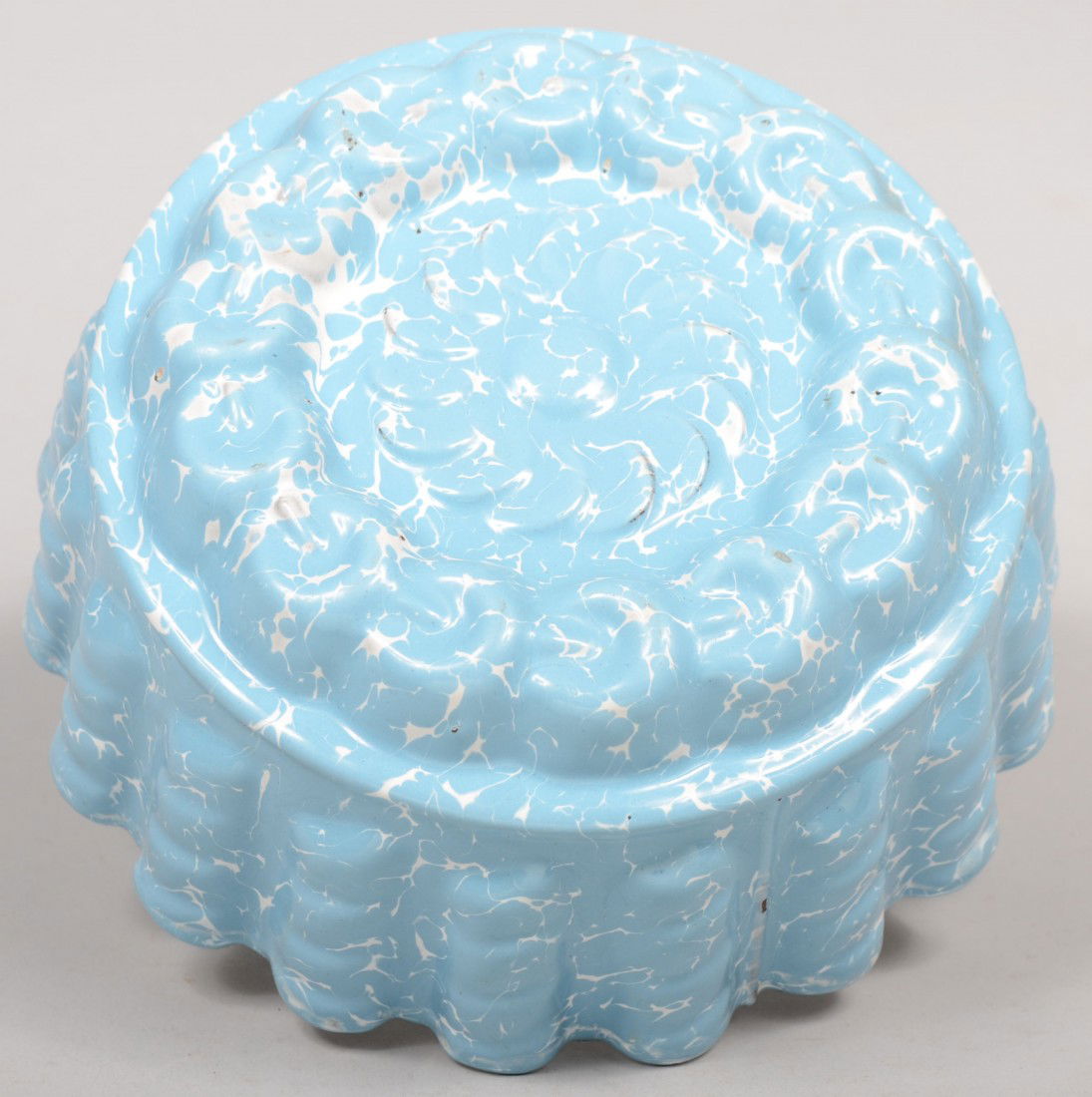 Food Mold. Light Blue and White Large Swirl. Skirt: Food Mold. Light Blue and White Large Swirl. Skirt seamed and seamed to press molded bottom. Riveted on hanging ring. Unmarked. 3 3/4"h. X 8 1/8"dia. Condition: Good, with use wear.