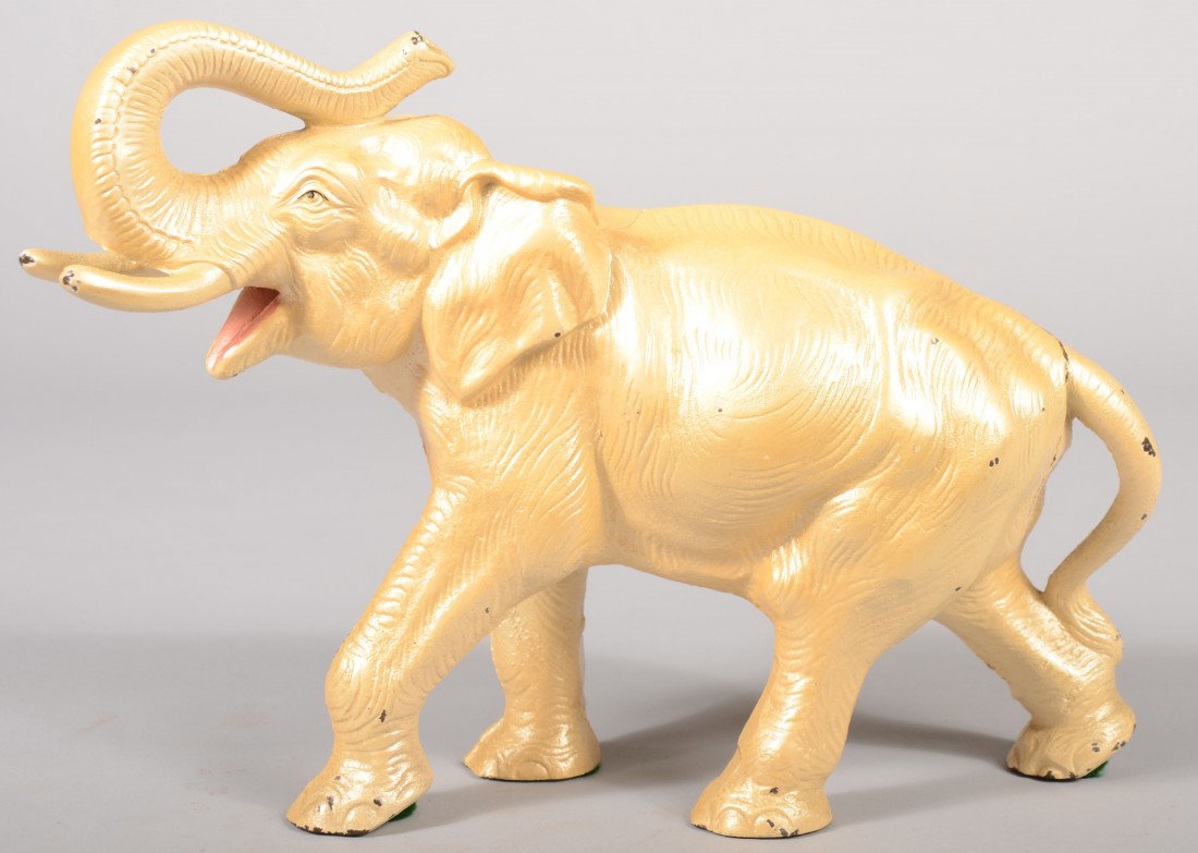 Hubley Pearl Painted Elephant Doorstop. Golden whi: Hubley Pearl Painted Elephant Doorstop. Golden white with pink mouth. 11 1/4"l. Condition: A few paint chips.